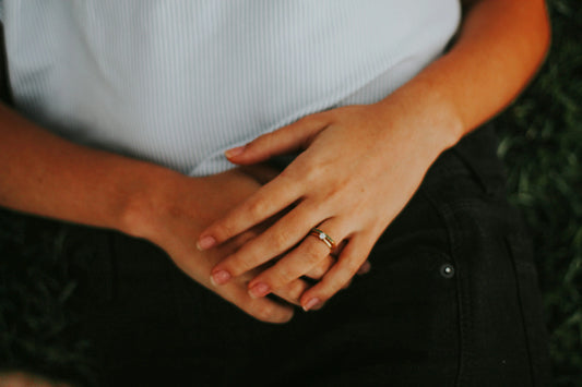 Close up of person lying down with hands over their stomach